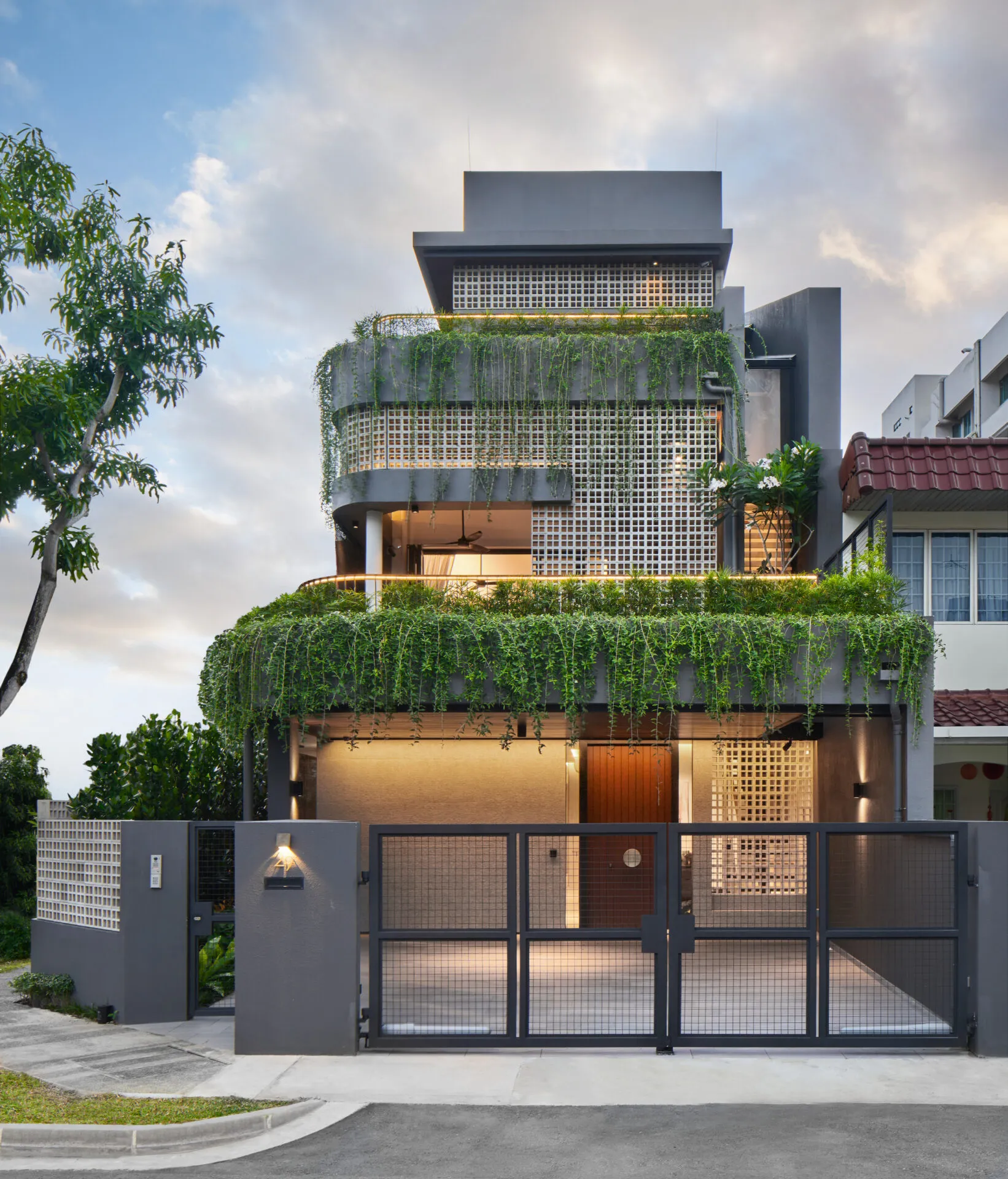 Contemporary residential facade with greenery – architectural photography.