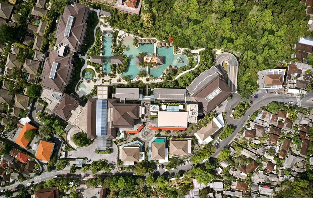 Top-down drone view of resort complex with pool and rooftop bar — Above Eleven Bali aerial photography