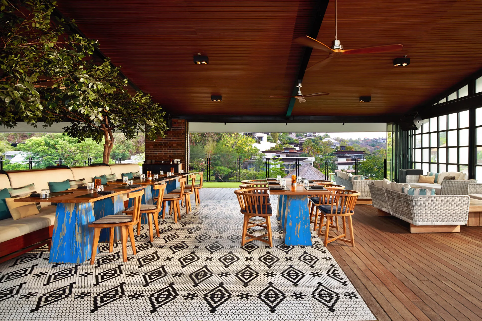 Open-sided dining with timber ceiling, mosaic floor and hillside views — Above Eleven Bali restaurant photography