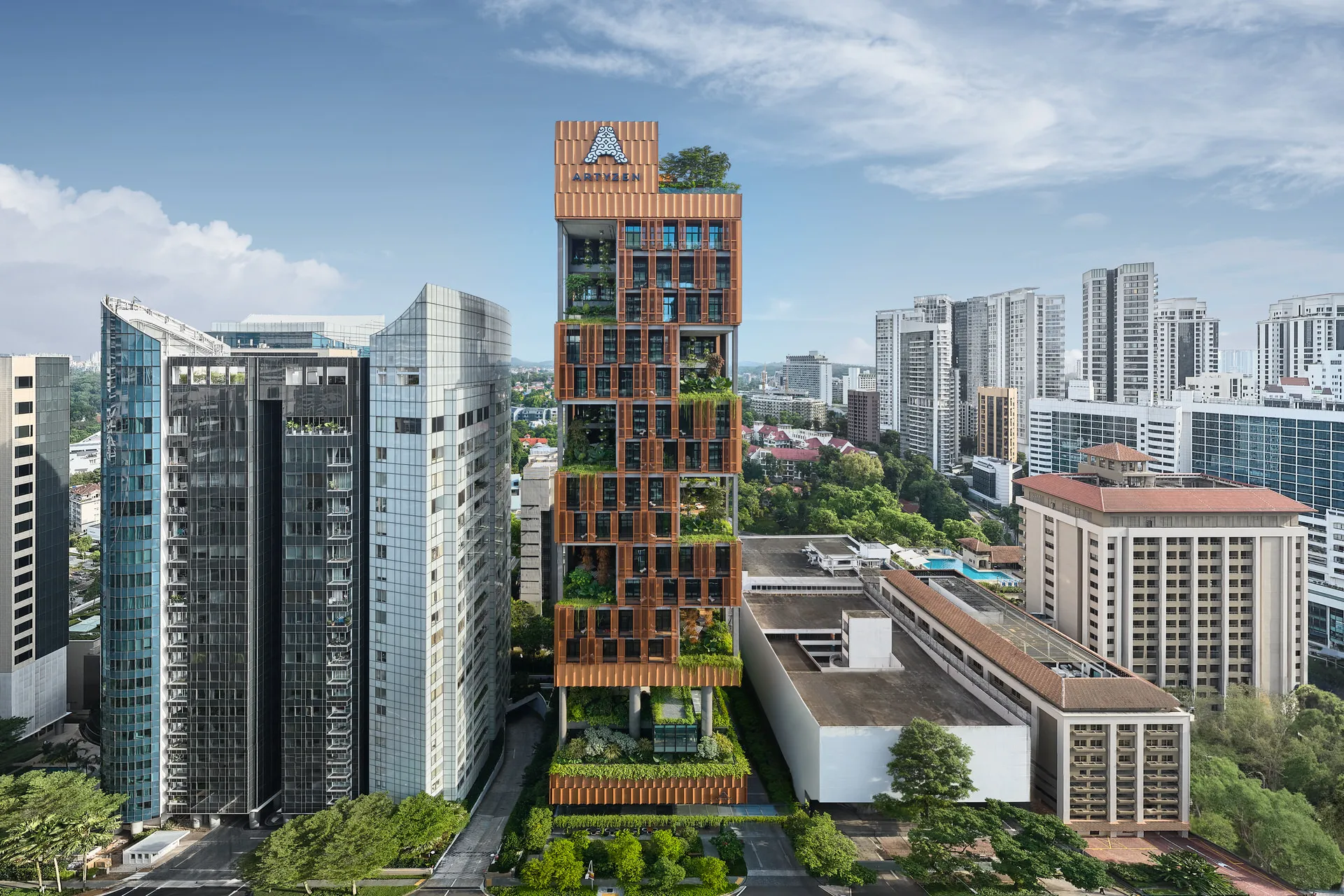 Aerial of terracotta tower with vertical greenery above landscaped podium — Artyzen Singapore architectural photography