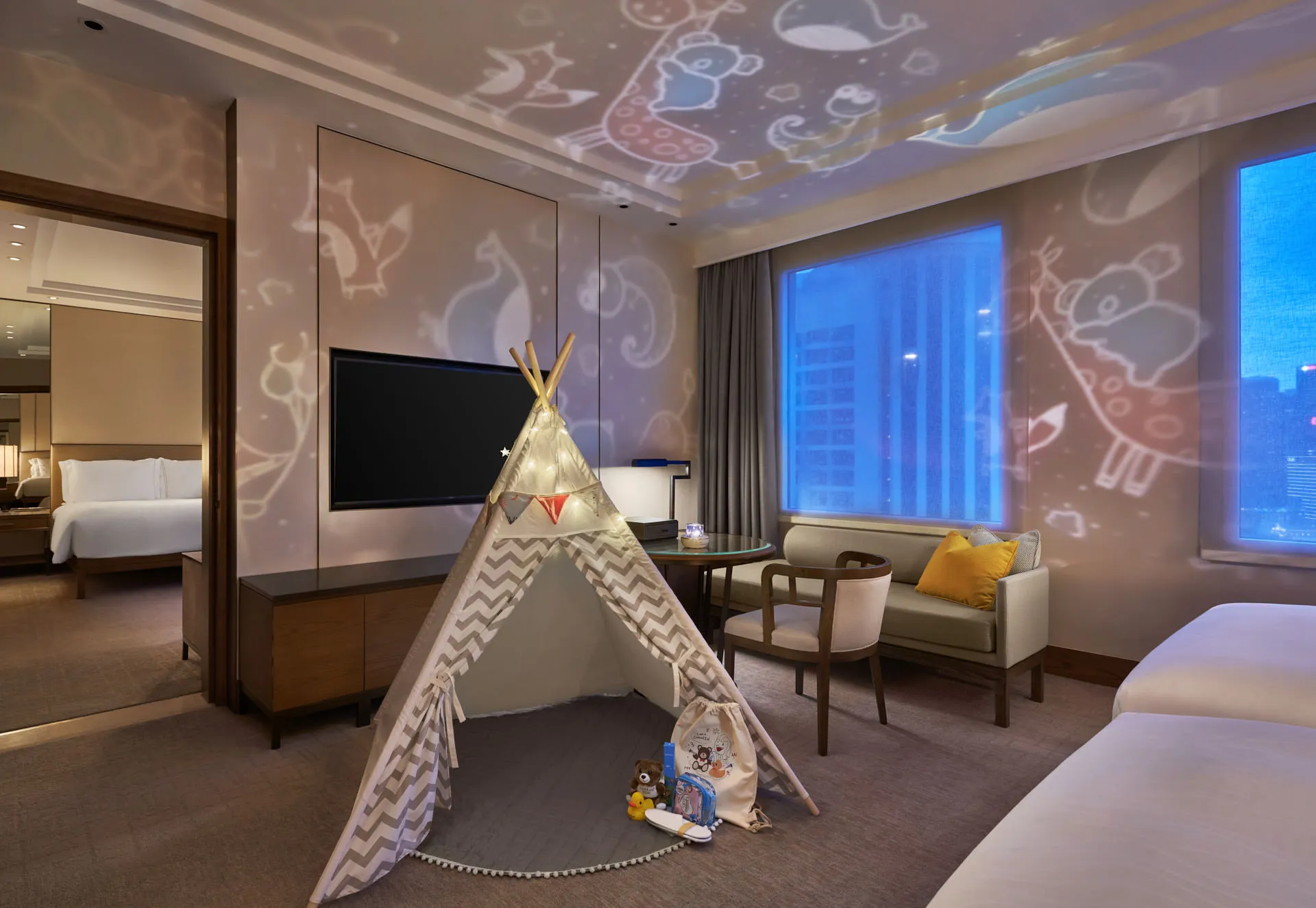 Family suite with teepee tent, fairy lights and animal projector at night — Conrad Centennial Singapore hotel photography