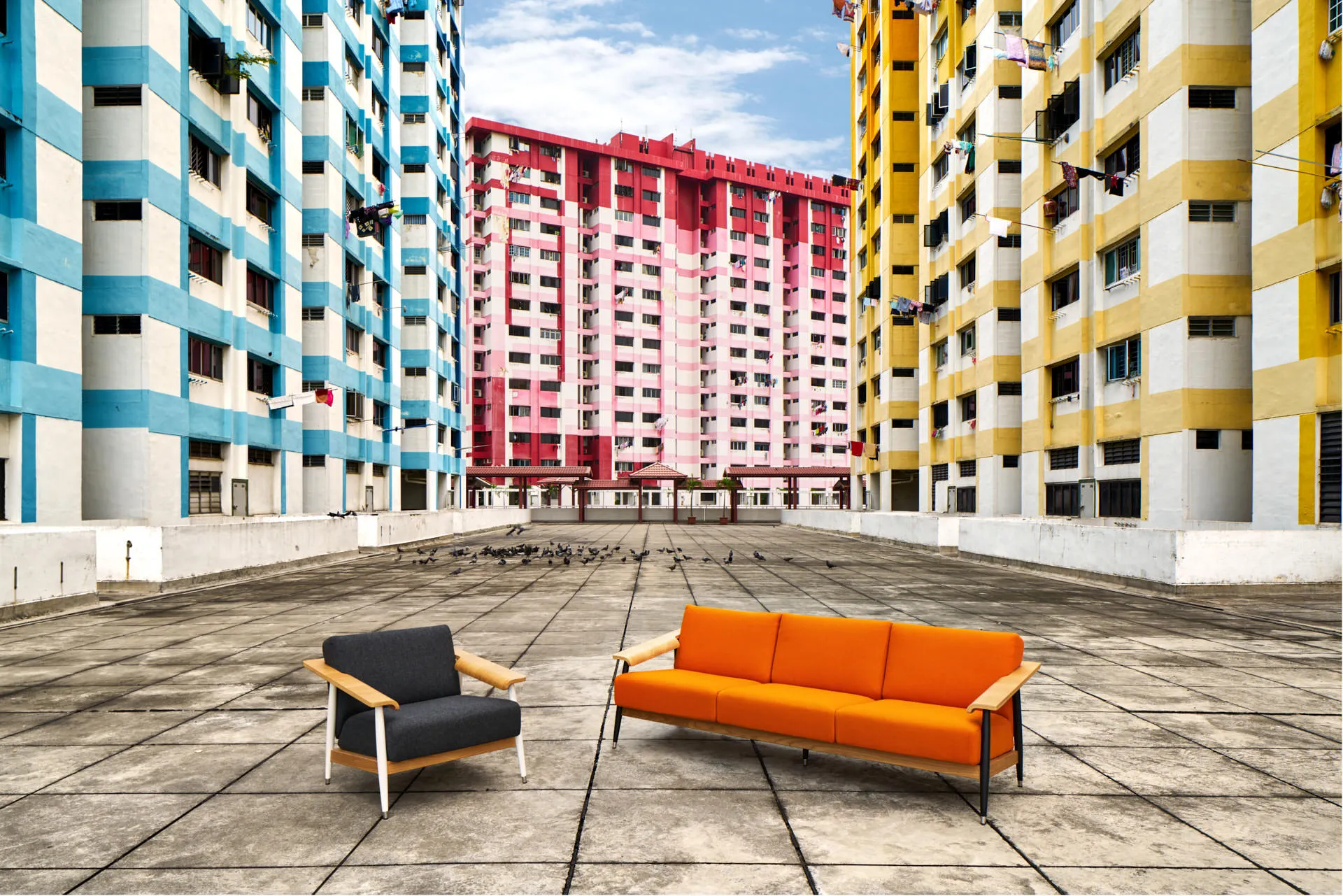Armchair and sofa staged before colourful HDB tower blocks — Momentum Creations Singapore product photography