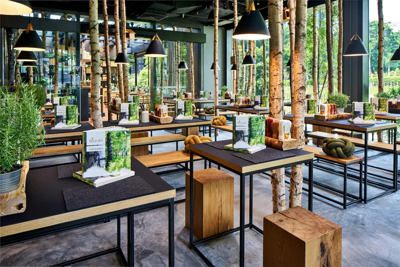Commercial interior photography of Hans Im Gluck restaurant, designed by WOLF, featuring the main dining space with wooden furniture and contemporary design.