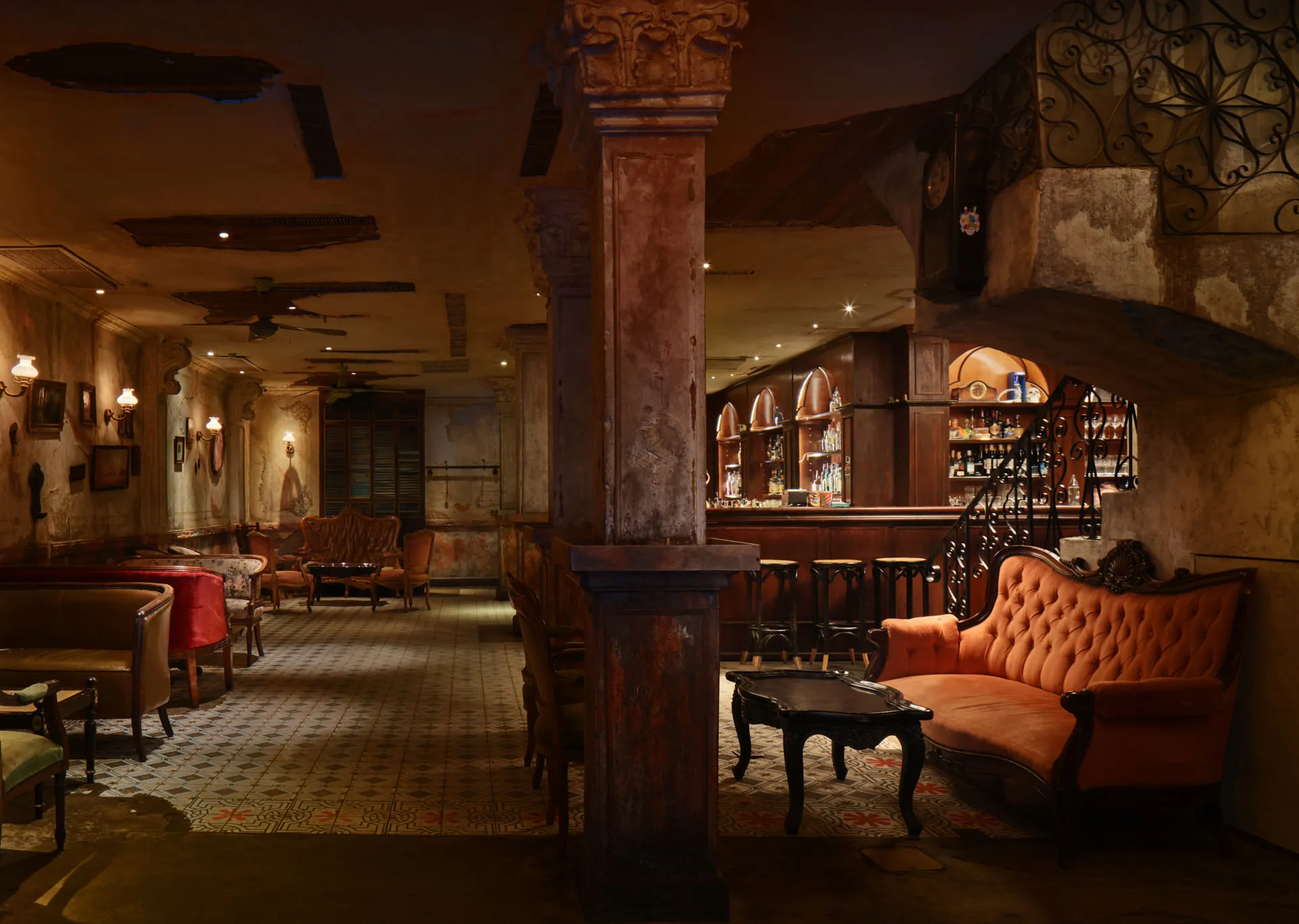 Full venue with mahogany bar, weathered columns and vintage sconces — Havana Social Bangkok interior photography