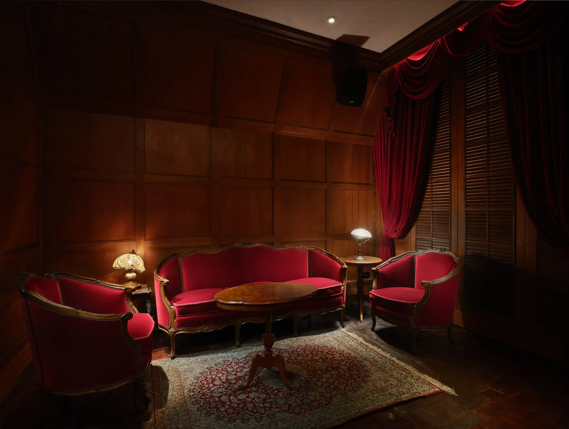 VIP parlor with mahogany panels, red velvet furniture and Tiffany lamps — Havana Social Bangkok interior photography