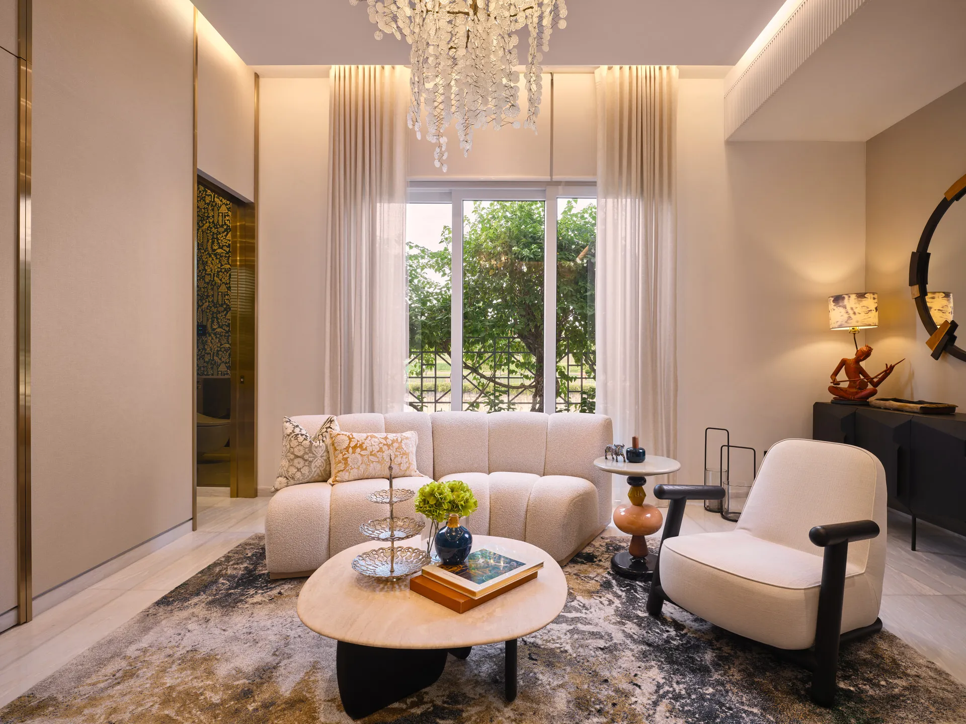 Double-height living room with pearl chandelier and bouclé sofa — Holland Green Singapore interior design photography