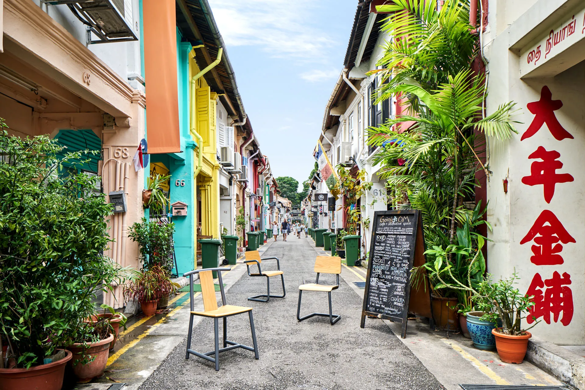 Four cantilever chairs scattered down Haji Lane with shophouse backdrop — Momentum Creations Singapore furniture photography
