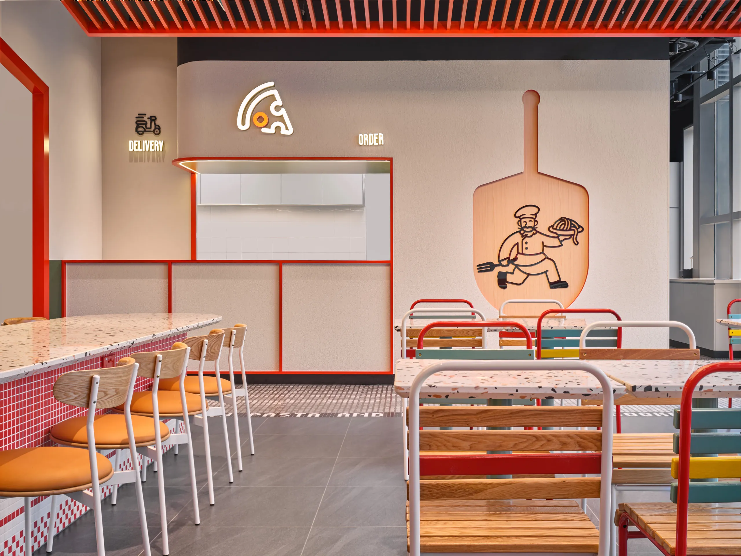 Order counter with neon pizza logo, red slatted ceiling and timber shelving — PastaMania City Square Mall restaurant photography