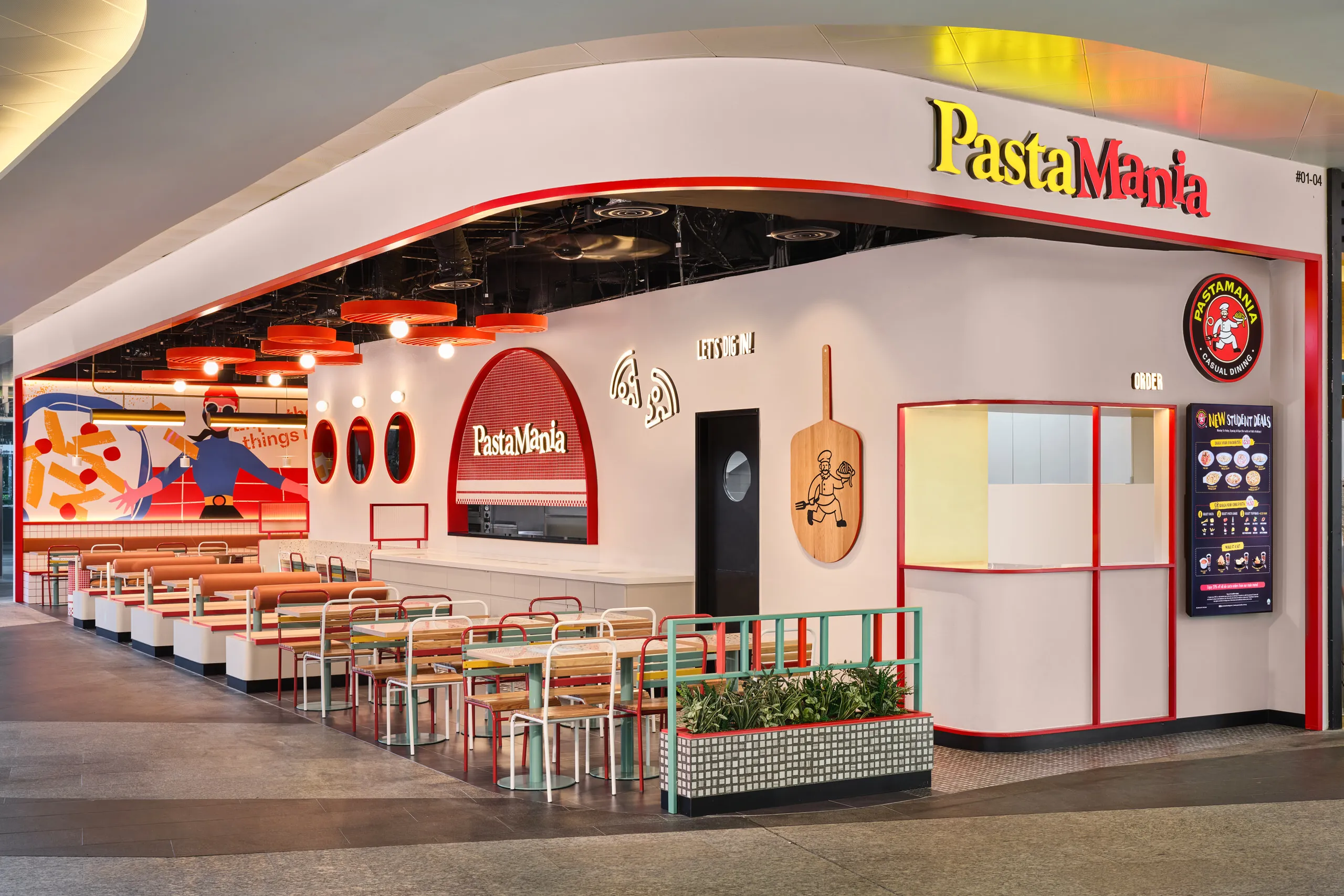 Red slatted disc pendant lights over booth seating — PastaMania Fusionopolis interior design photography