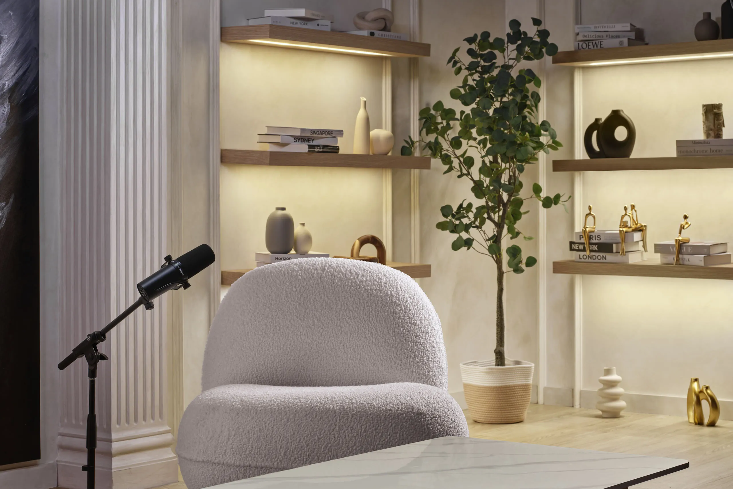 Glam studio detail with marble table, microphones and abstract art — Poddster Singapore interior photography