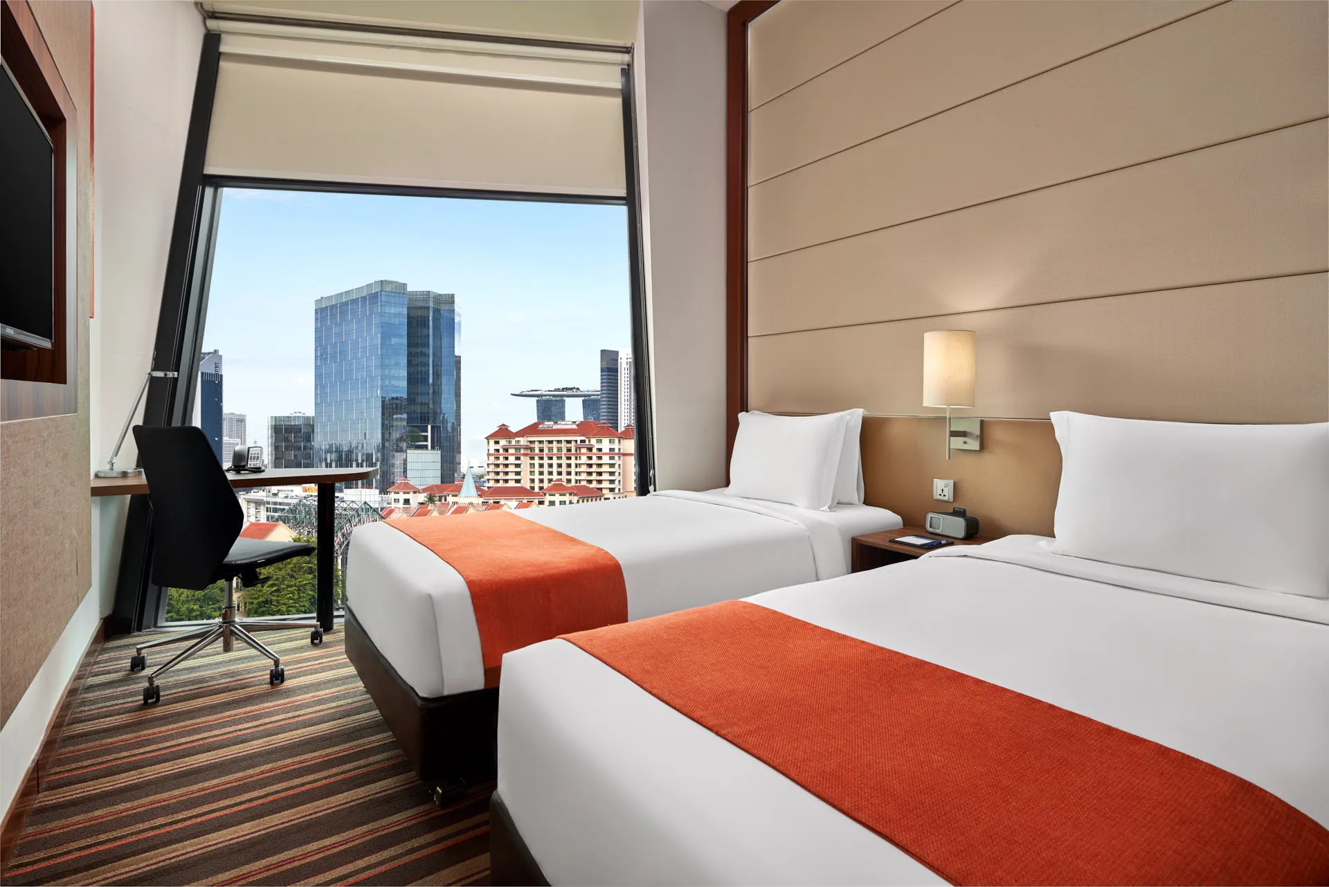 Twin room with city skyline view through floor-to-ceiling window — Holiday Inn Express Clark Quay hotel photography