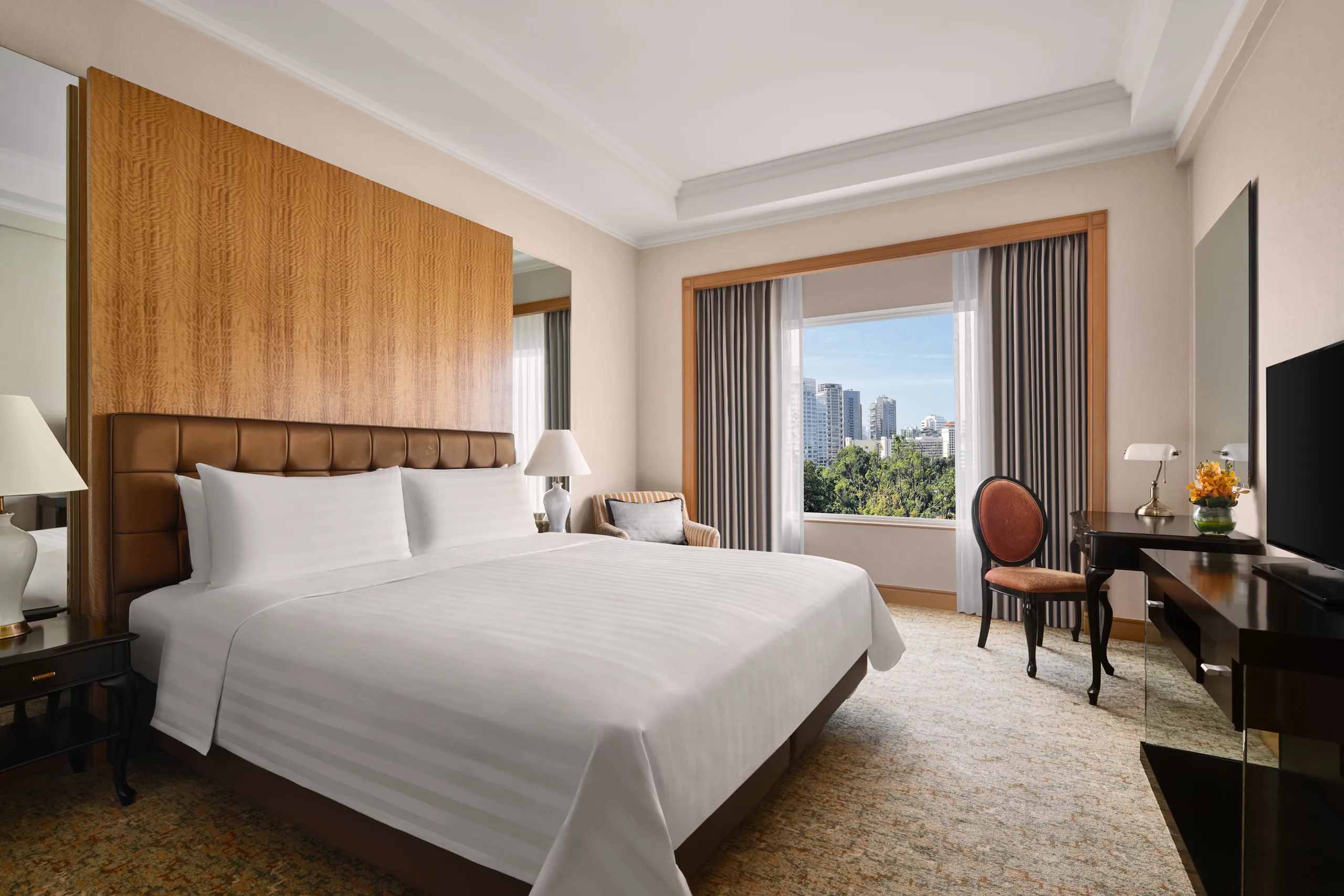 King bedroom with leather headboard, desk and city skyline view, Shangri-La Residences Singapore, hospitality photography