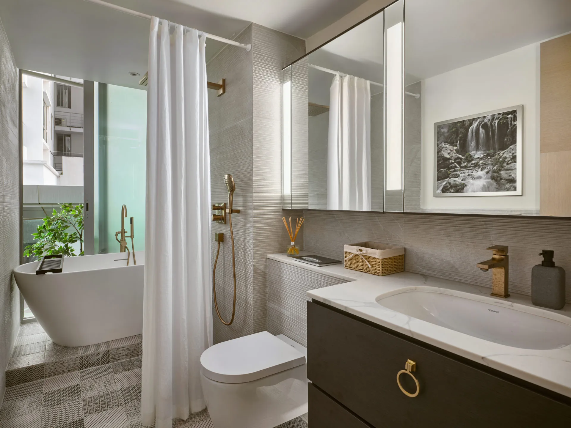 Spa bathroom with freestanding tub, marble vanity and geometric floor — Oceanfront Sentosa Cove interior photography