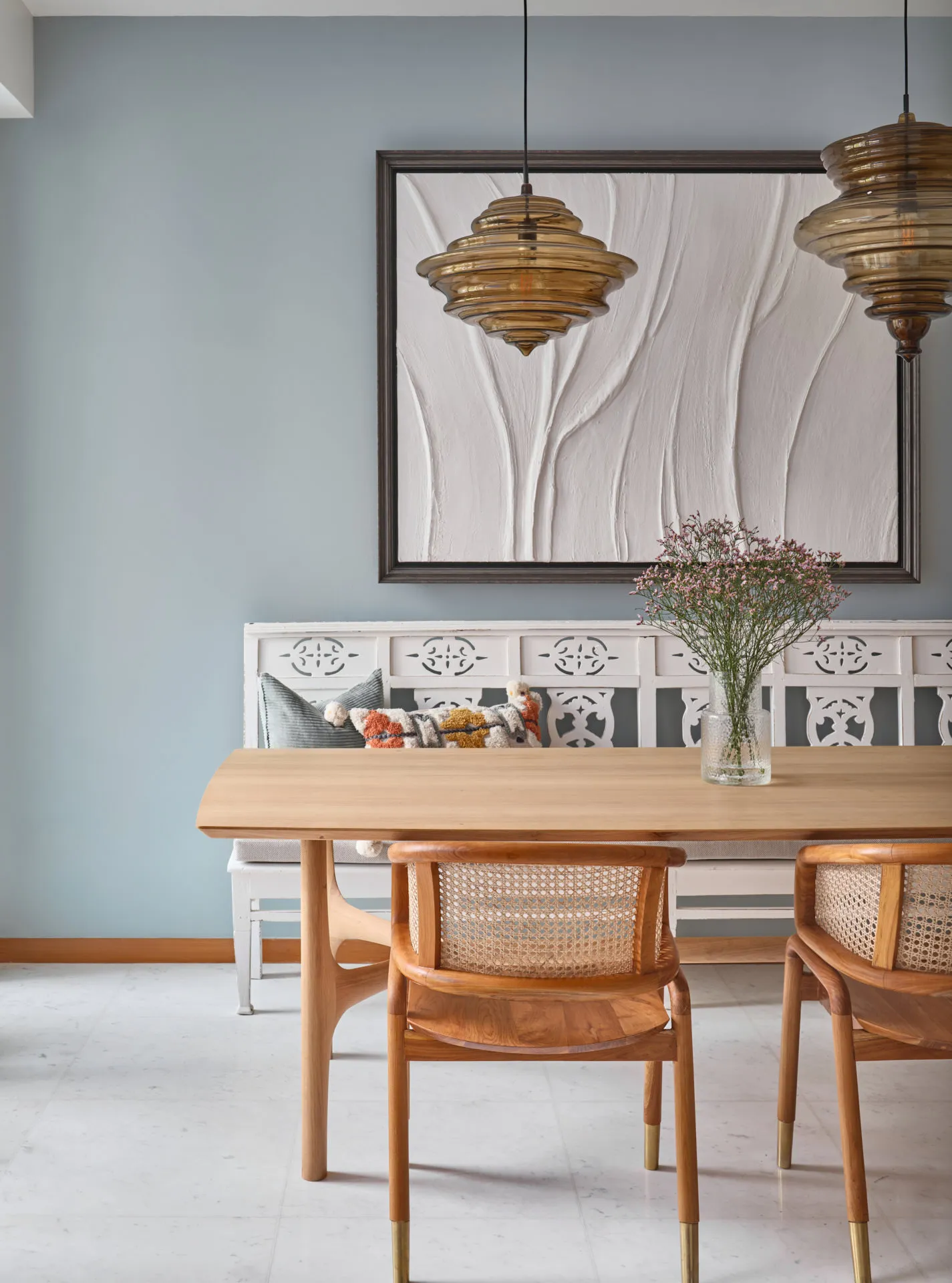 Dining nook with duck-egg walls, cane chairs and amber glass pendants — Oceanfront Sentosa Cove interior photography