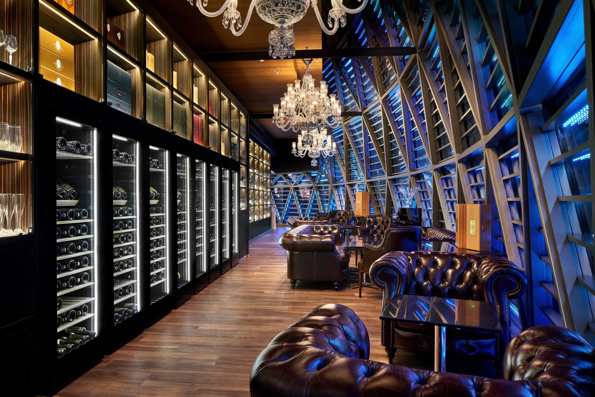 Champagne lounge with Chesterfield chairs, crystal chandeliers and wine cabinets — The Whiskey Trust Singapore photography