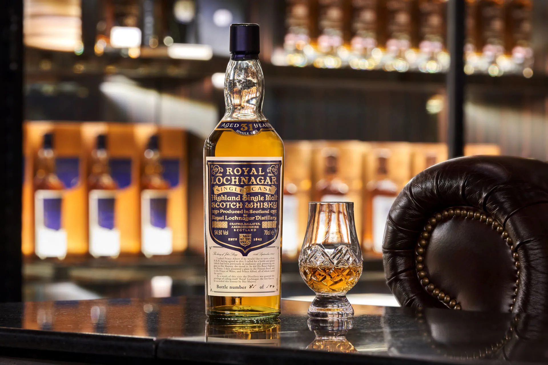 Royal Lochnagar 31-year single malt with Glencairn glass and bokeh shelves — The Whiskey Trust Singapore product photography