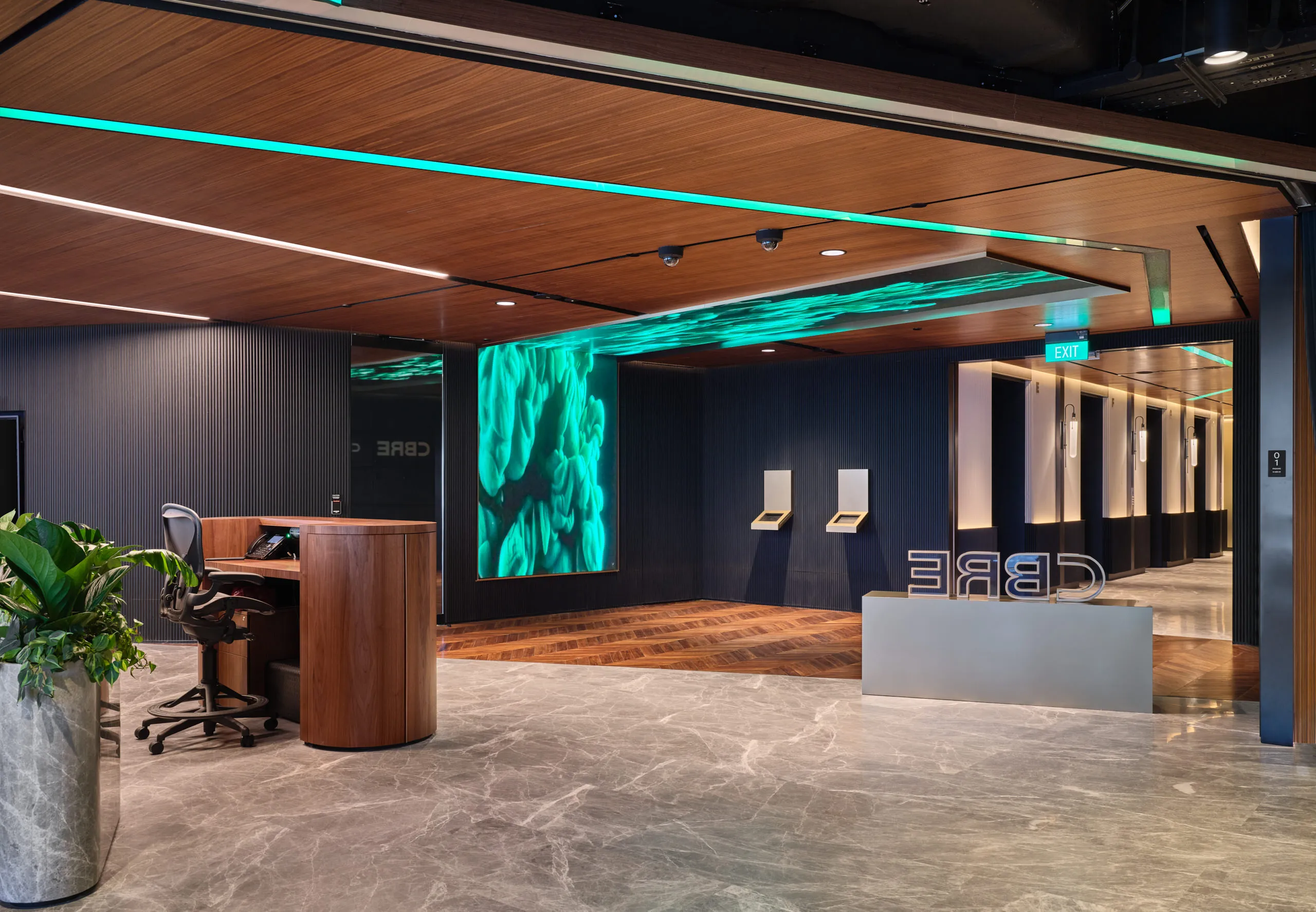leek CBRE reception area featuring a large green moss wall art installation and contemporary seating, an example of corporate interior photography.