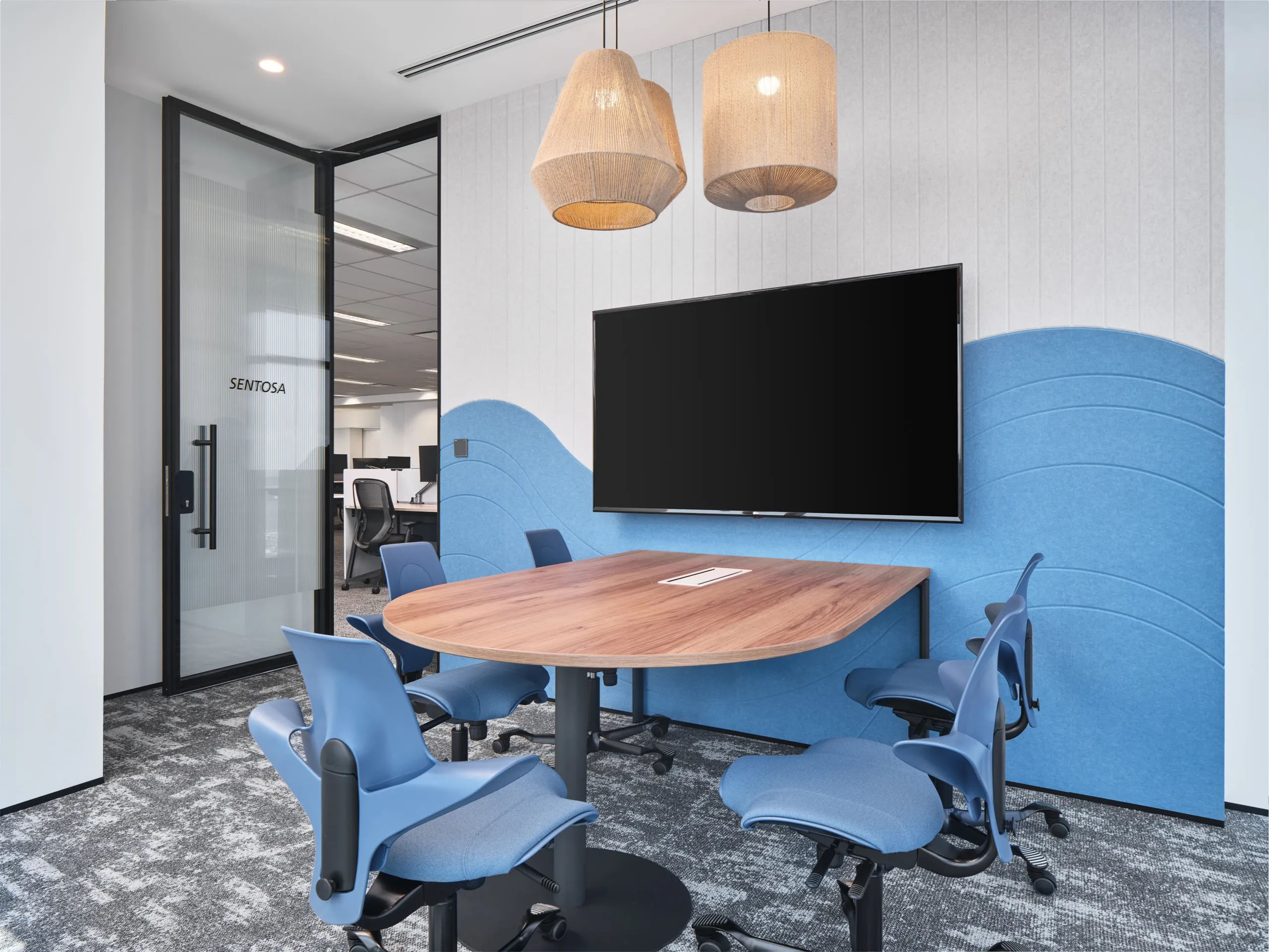 Sentosa meeting room with wave acoustic panels and woven pendants — Singapore workplace photography