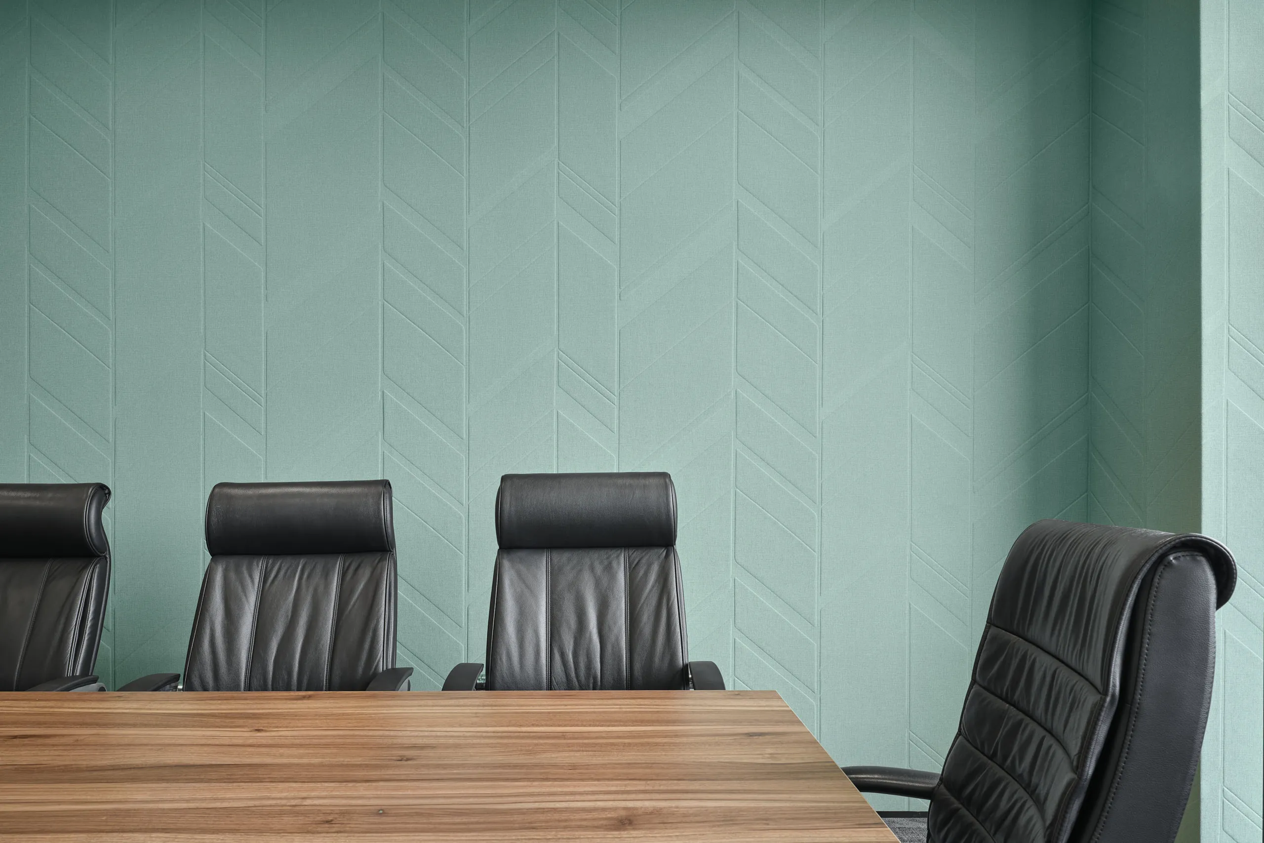 Executive boardroom with walnut table and mint chevron acoustic panels — Singapore workplace photography